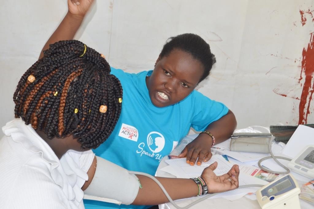 A officer from KMET - a partner at the clinic, attends to a member of the public.